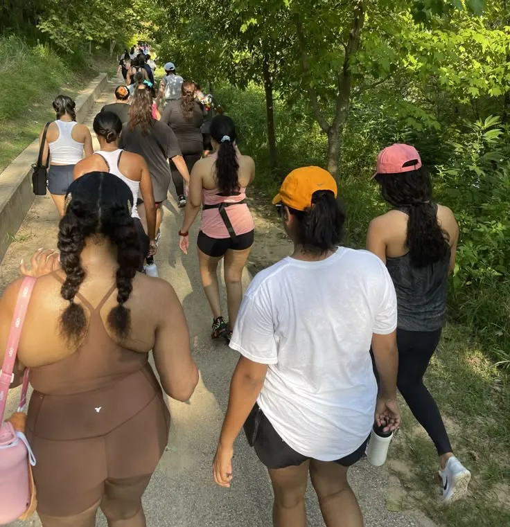Group of walkers assembling at a trailhead meeting point