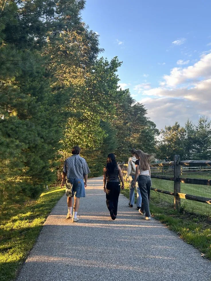 Walkers on a scenic ridge trail with valley views
