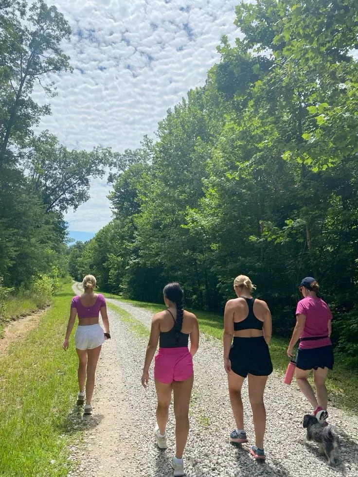 Walkers gathered at a trail junction signpost